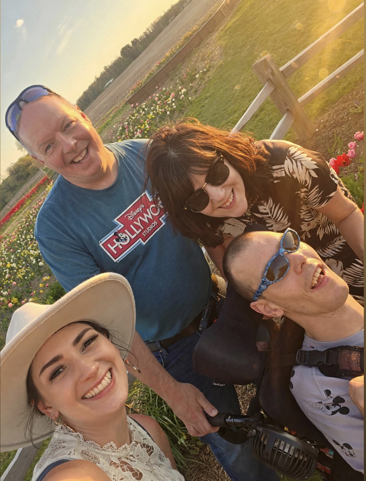 Anna Marie taking a selfie with family in a flower field