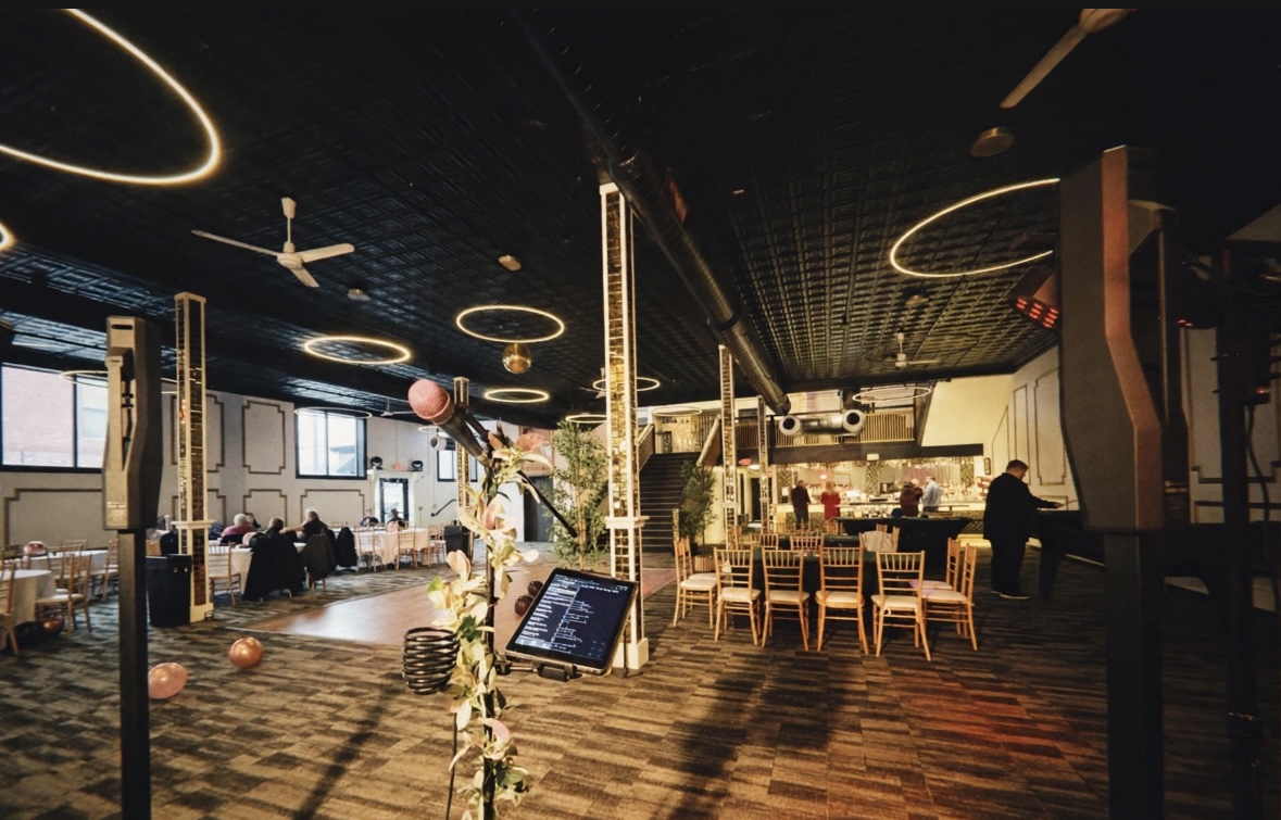 Anna Marie's setup at a 50th birthday party — microphone, speakers, and a warm event space ready for guests