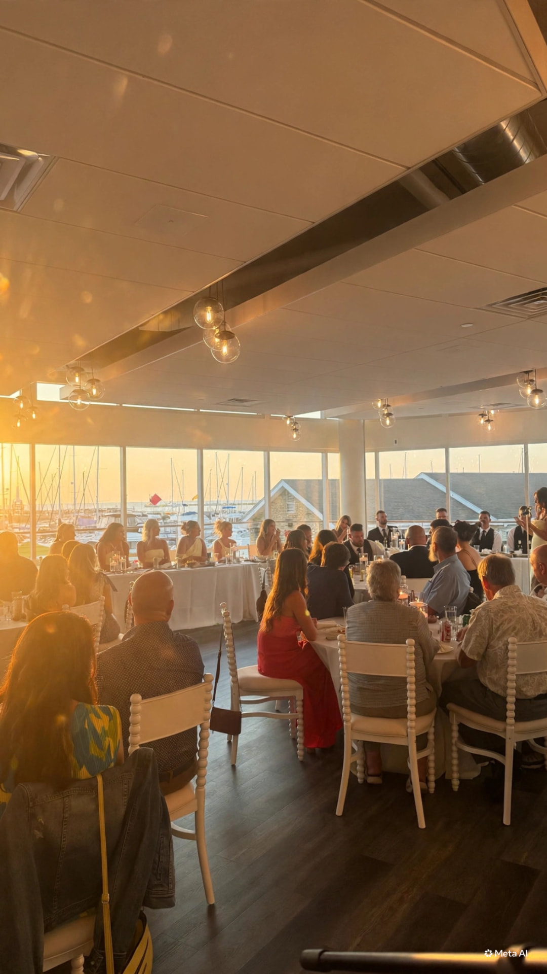 Wedding reception dinner at golden hour overlooking the marina