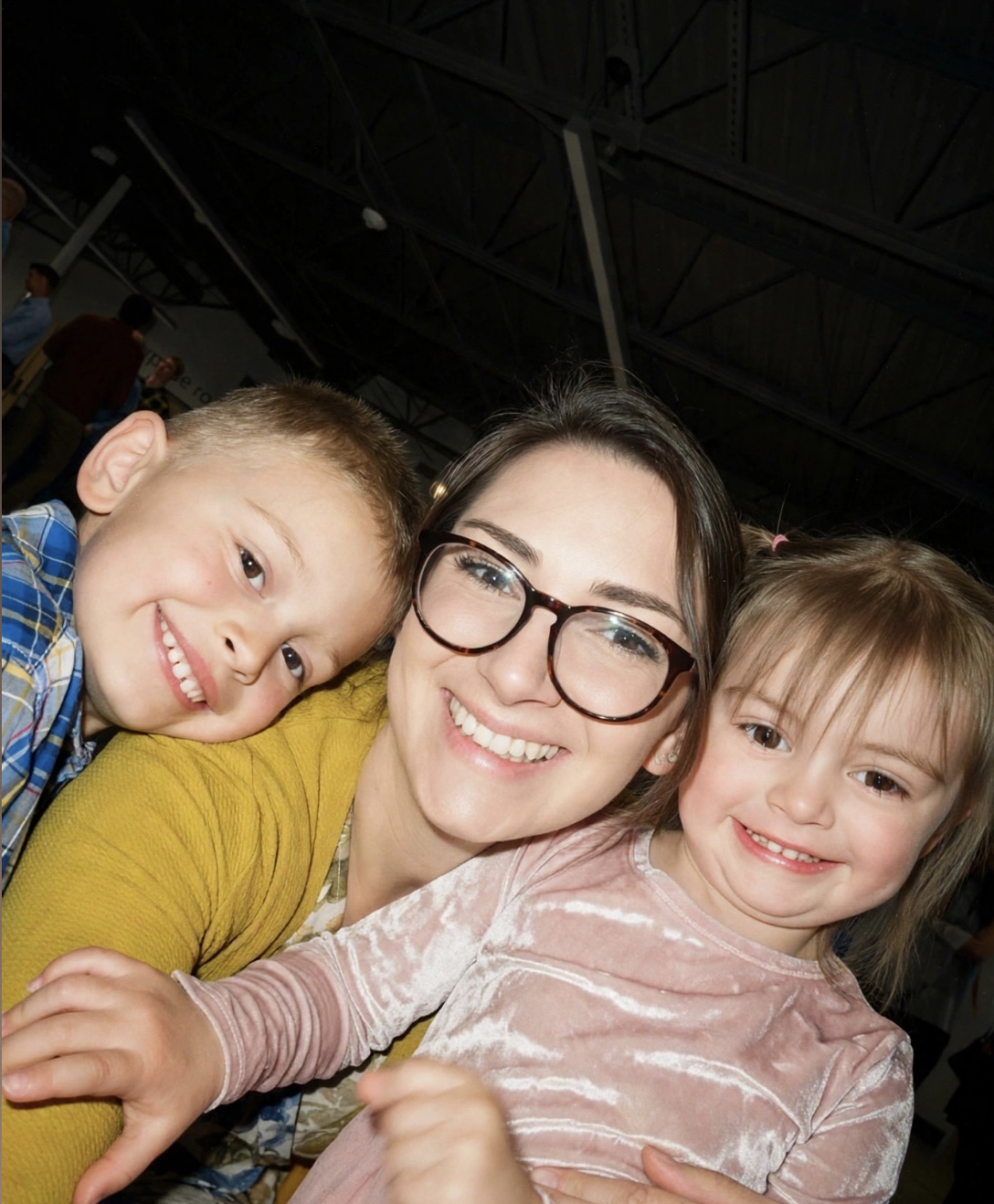 Anna Marie smiling with her two children